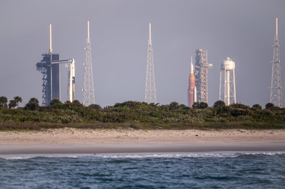 Close-up photo of the NASA SLS rocket at sunset on pad LC-39B with a flock of birds, taken on a Star Fleet boat tour
